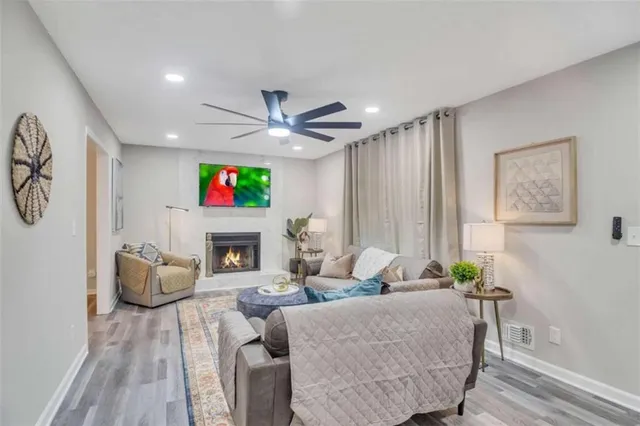 a living room with fireplace furniture and a large window