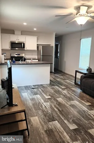 a kitchen with stainless steel appliances kitchen island granite countertop a stove and a sink
