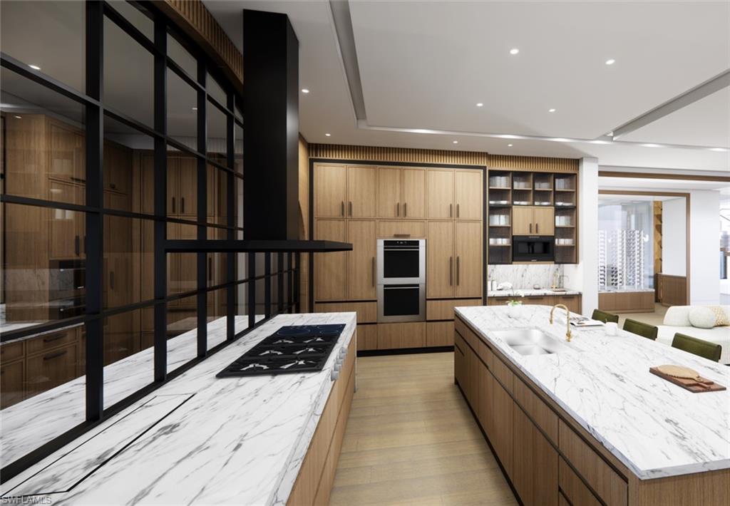 616 Bougainvillea Road Naples, FL 34102 - Photo 5 of 21 Kitchen featuring a sink, double oven, stovetop, a large island, and light stone countertops
