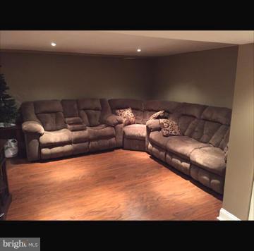 2763 Kirkleigh Road Baltimore, MD 21222 - Photo 14 of 16 a living room with furniture and a flat screen tv