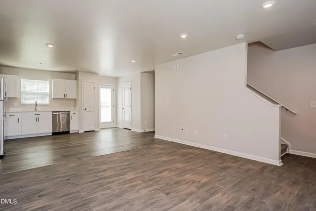 a view of a kitchen with a sink and dishwasher wooden floor