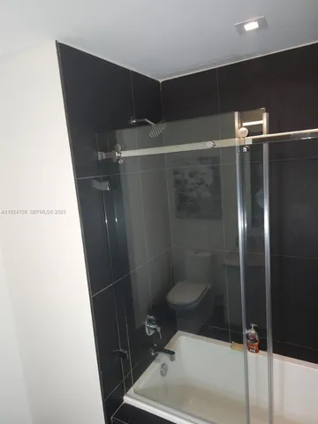 a bathroom with a shower and a sink