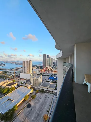 a living room with furniture stove and kitchen view