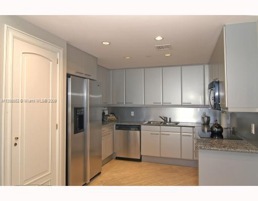 South of Fifth Miami Beach, FL 33139 - Photo 4 of 8 a kitchen with stainless steel appliances granite countertop a refrigerator sink and cabinets