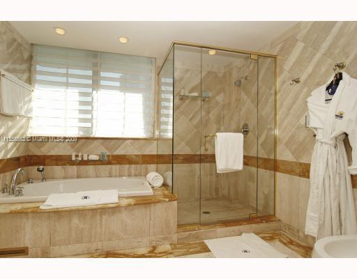 South of Fifth Miami Beach, FL 33139 - Photo 5 of 8 a bathroom with a tub shower and sink