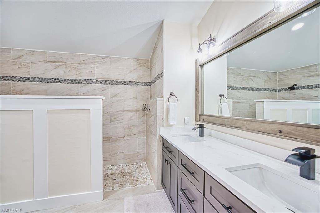 3700 Kent Drive Naples, FL 34112 - Photo 14 of 31 a bathroom with a sink and a mirror