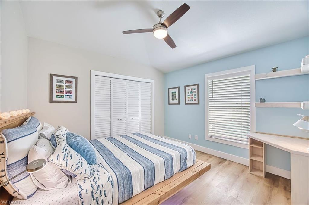 3700 Kent Drive Naples, FL 34112 - Photo 16 of 31 a bedroom with a bed and a chandelier