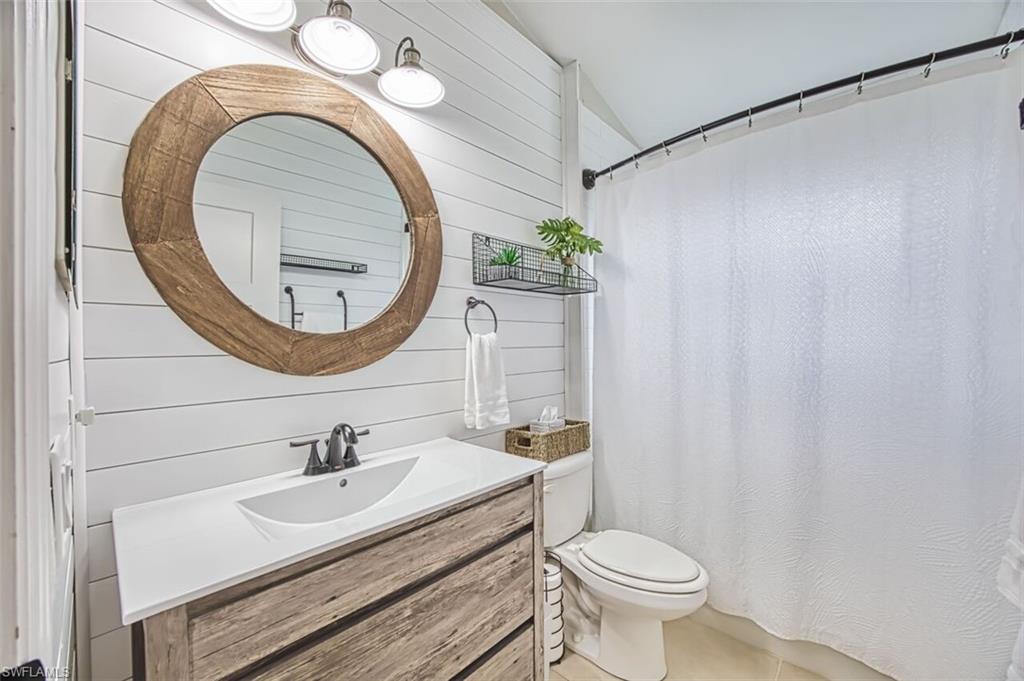 3700 Kent Drive Naples, FL 34112 - Photo 18 of 31 a bathroom with a sink and a mirror