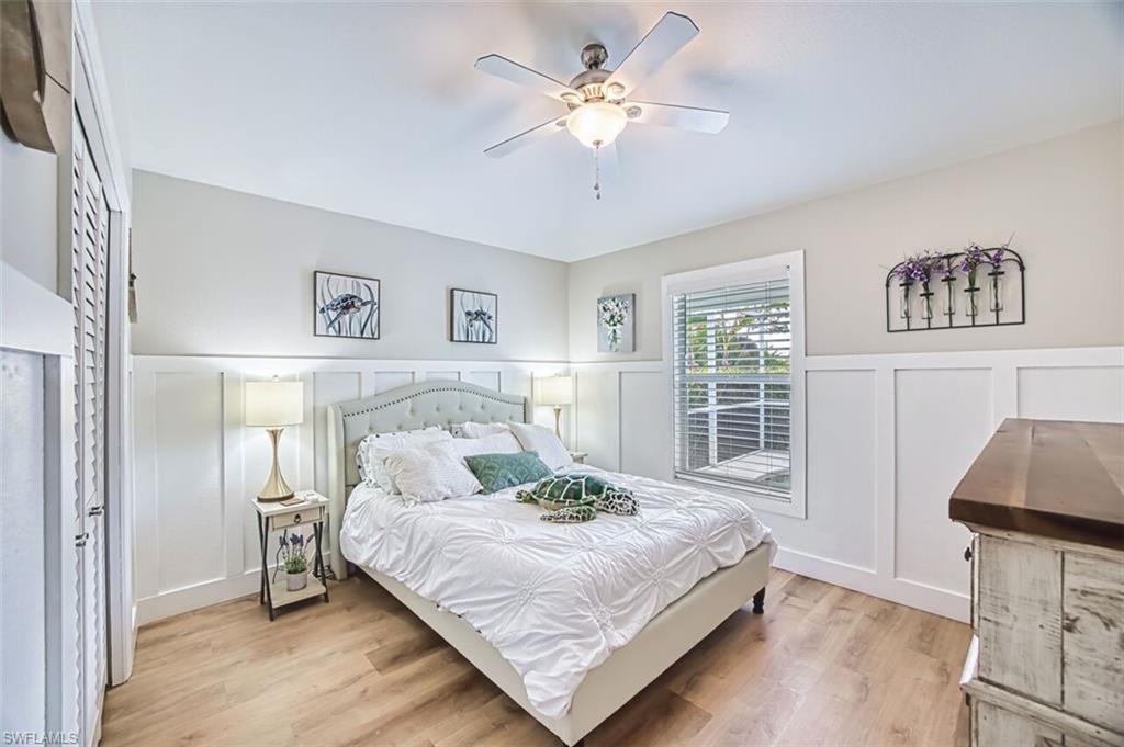 3700 Kent Drive Naples, FL 34112 - Photo 19 of 31 a bedroom with a large bed and a chandelier