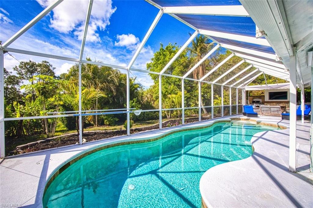 3700 Kent Drive Naples, FL 34112 - Photo 22 of 31 a view of a swimming pool with a porch