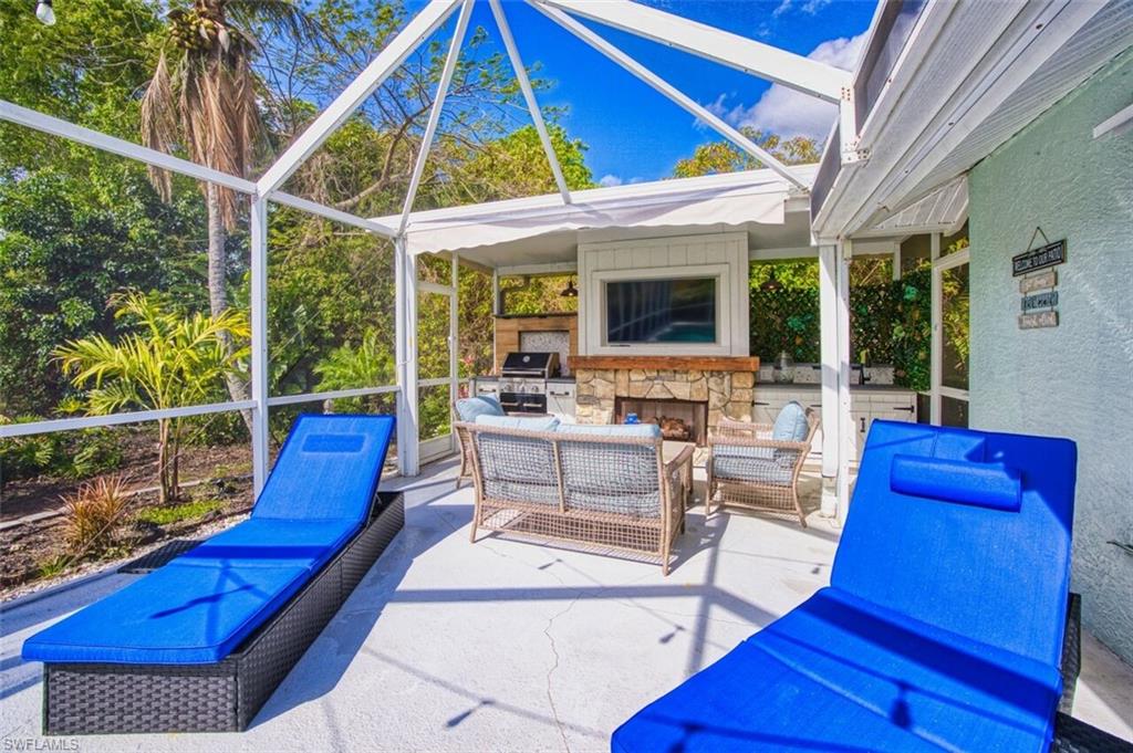 3700 Kent Drive Naples, FL 34112 - Photo 23 of 31 a view of an outdoor sitting area with a table and chairs