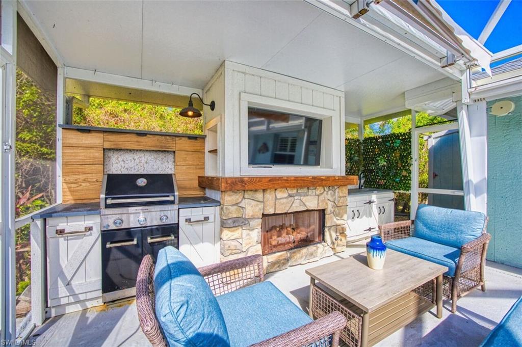 3700 Kent Drive Naples, FL 34112 - Photo 24 of 31 a living room with furniture and a fireplace
