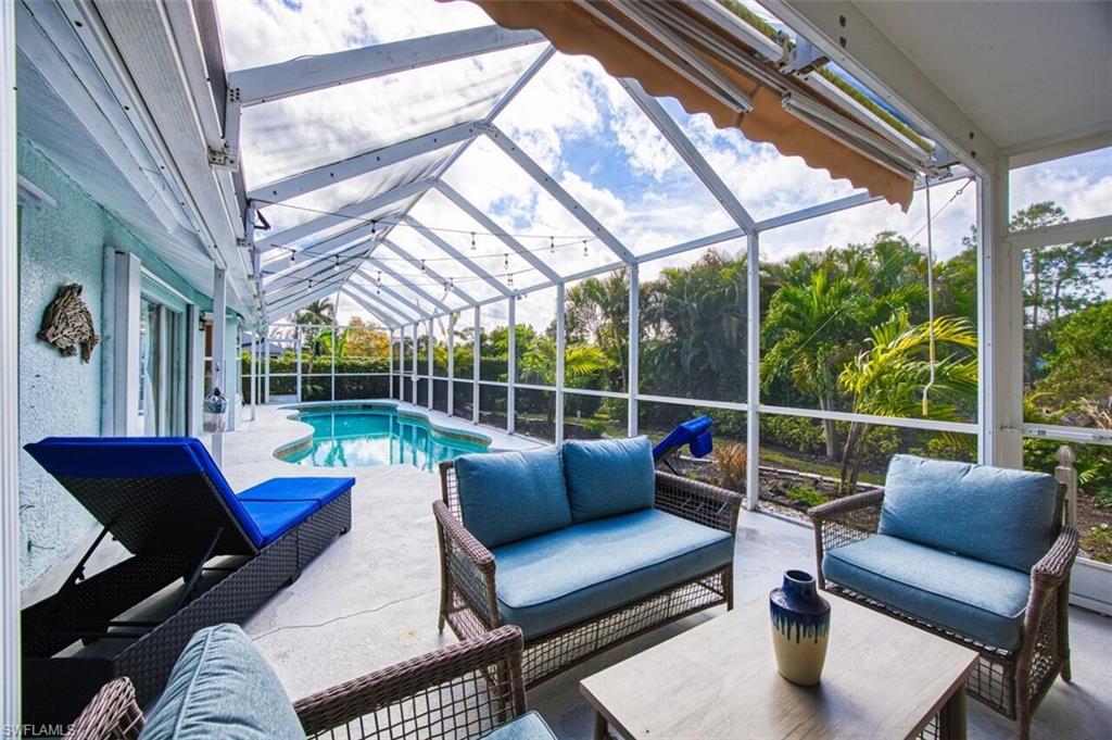 3700 Kent Drive Naples, FL 34112 - Photo 25 of 31 a balcony with furniture and a large window