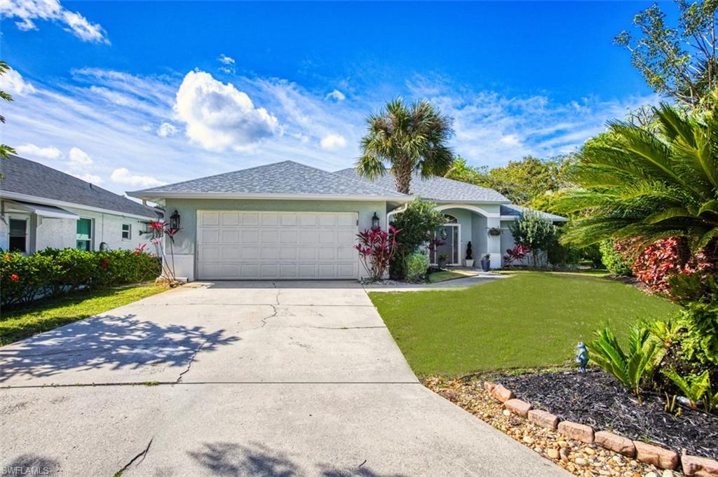 3700 Kent Drive Naples, FL 34112 - Photo 27 of 31 a front view of a house with a garden