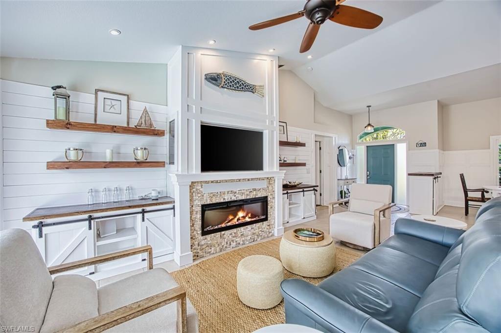 3700 Kent Drive Naples, FL 34112 - Photo 5 of 31 a living room with furniture and a fireplace
