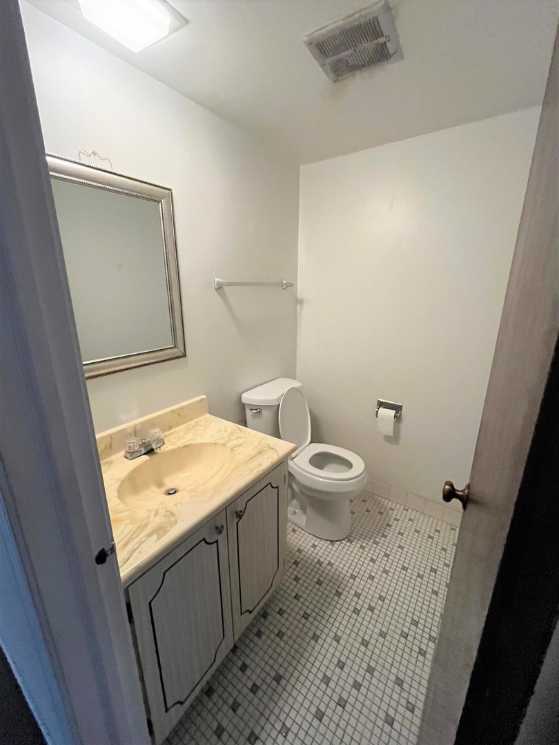 264 East Bailey Road, Unit G Naperville, IL 60565 - Photo 8 of 9 a bathroom with a granite countertop sink toilet and shower