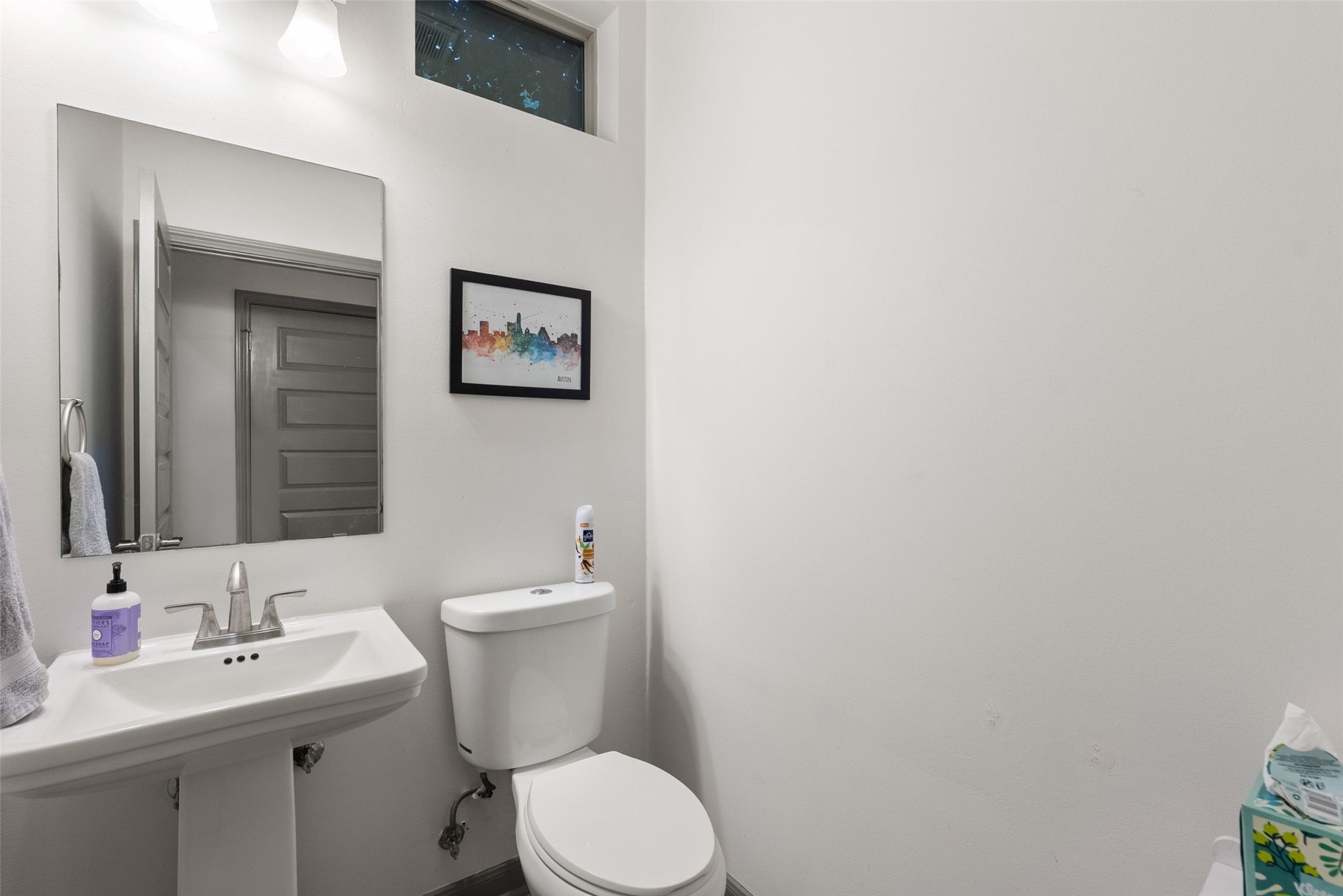 1158 Ridgeway Drive, Unit A Austin, TX 78702 - Photo 20 of 28 A compact and functional bathroom, featuring a clean pedestal sink and toilet, perfect for daily routines.