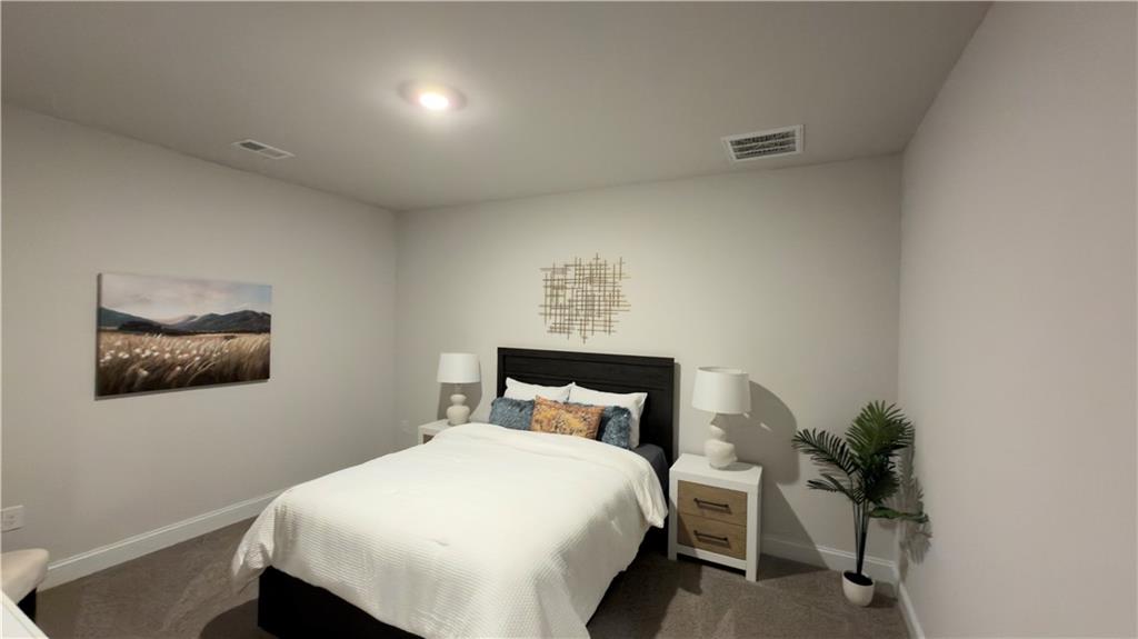 620 Bald Ridge Circle Demorest, GA 30535 - Photo 32 of 43 a bed sitting in a bedroom next to a window with potted plant