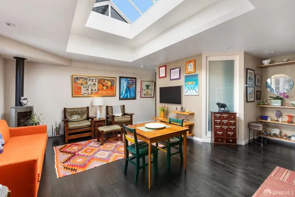 a living room with furniture a wooden floor and a flat screen tv