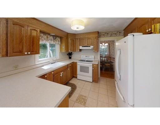 14 Upland Road Atkinson, NH 03811 - Photo 2 of 36 a kitchen with a refrigerator and a sink