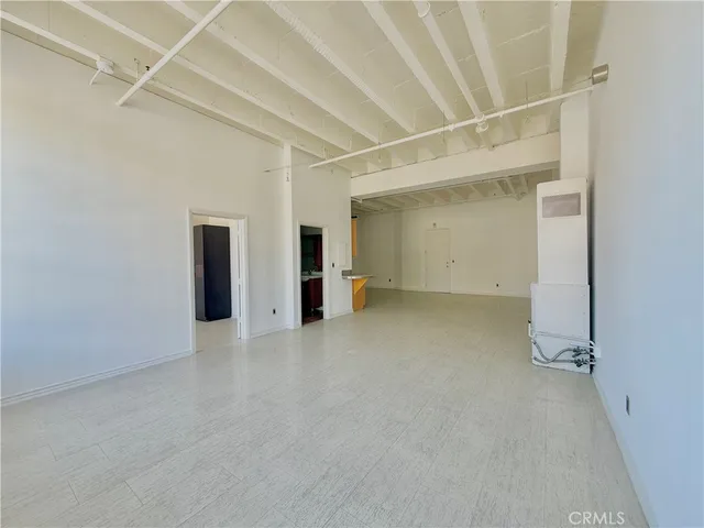 an empty room with closet and windows