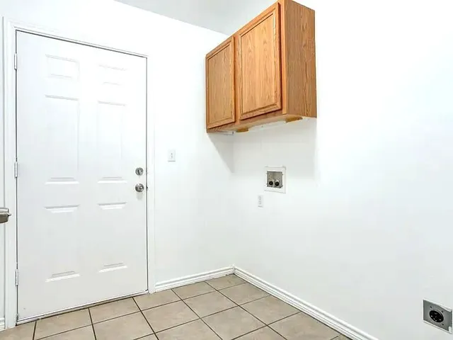 a view of a big room with closet and front door
