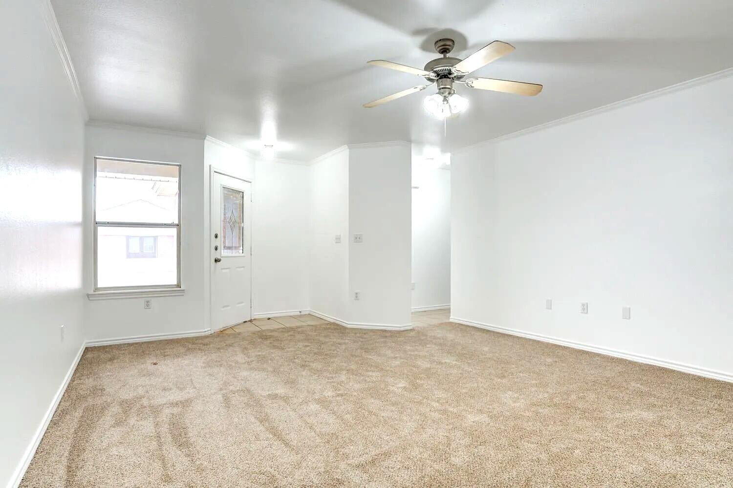 608 North Bangor Avenue Lubbock, TX 79416 - Photo 4 of 24 an empty room with windows and fan