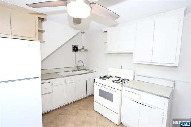 a kitchen with cabinets and white appliances