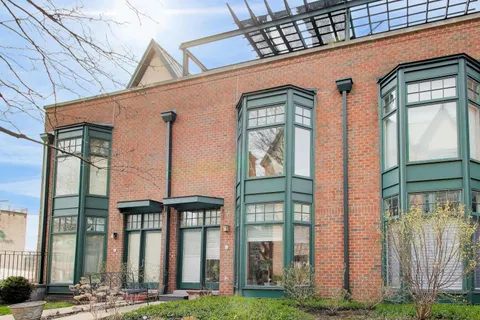 a front view of a building with a garden