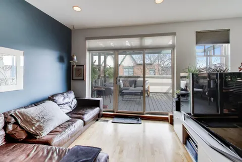 a living room with furniture and large window