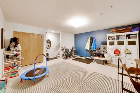 a room with gym equipment and lots of white walls