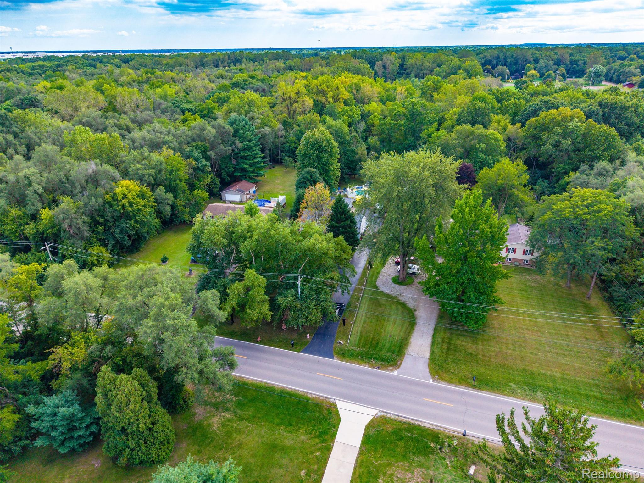 36739 Wick Road Romulus, MI 48174 - Photo 45 of 56 Expansive wooded surroundings with a curving driveway and mature trees