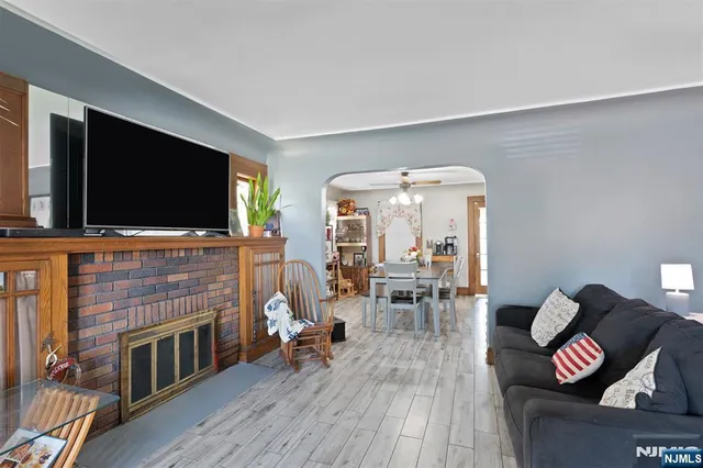 a living room with furniture fireplace and flat screen tv