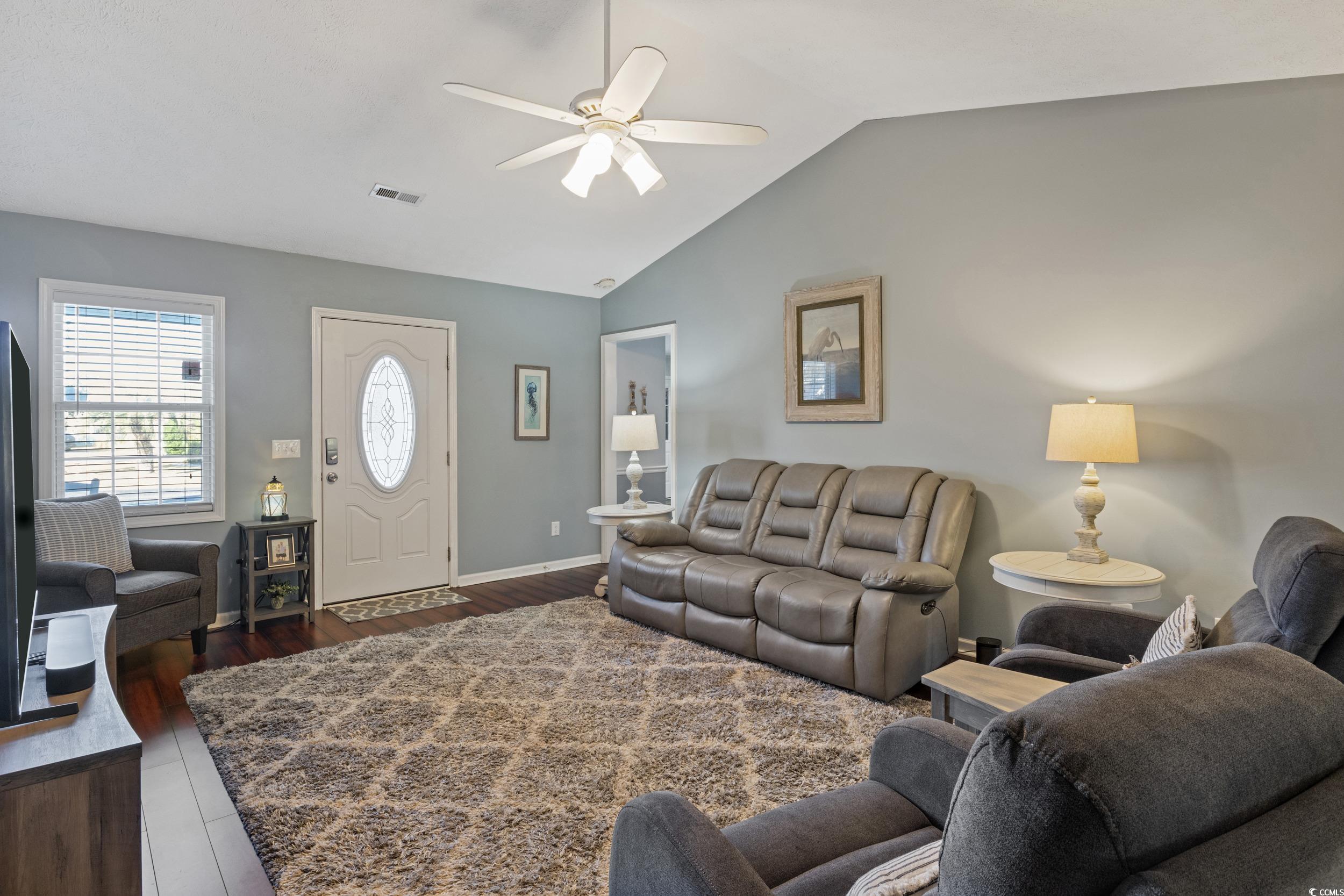 9605 Sullivan Drive Murrells Inlet, SC 29576 - Photo 13 of 40 Living room featuring ceiling fan, dark hardwood /