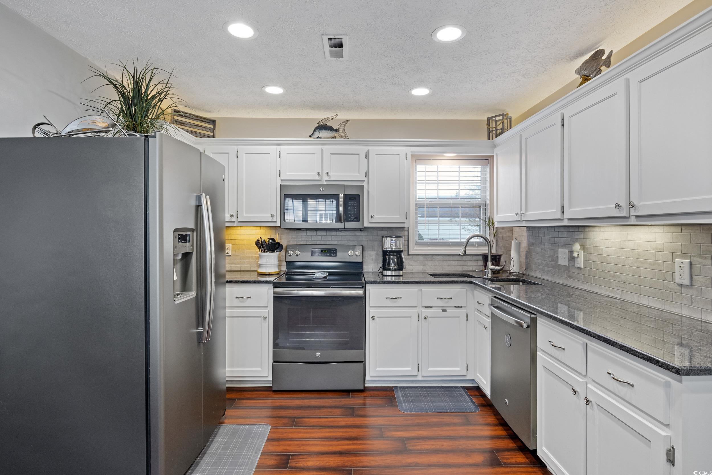 9605 Sullivan Drive Murrells Inlet, SC 29576 - Photo 19 of 40 Kitchen featuring stainless steel appliances, dark