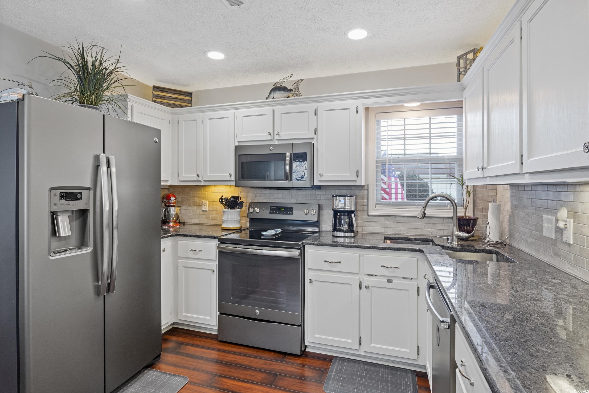 9605 Sullivan Drive Murrells Inlet, SC 29576 - Photo 20 of 40 Kitchen featuring white cabinets, appliances with