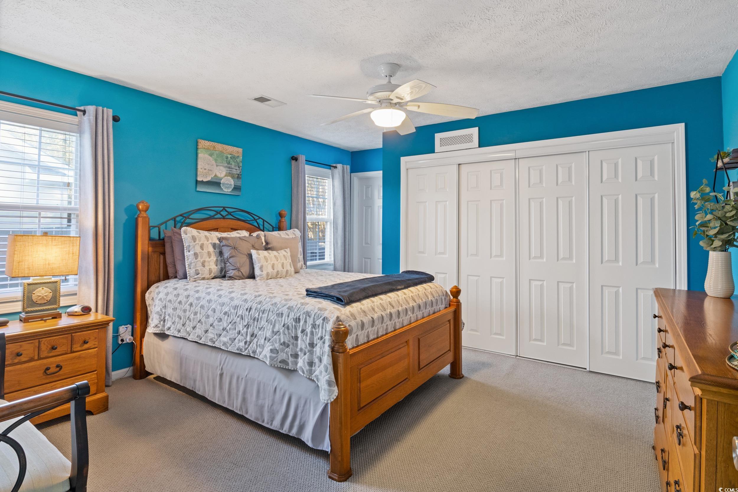 9605 Sullivan Drive Murrells Inlet, SC 29576 - Photo 25 of 40 Bedroom with ceiling fan, light colored carpet, an