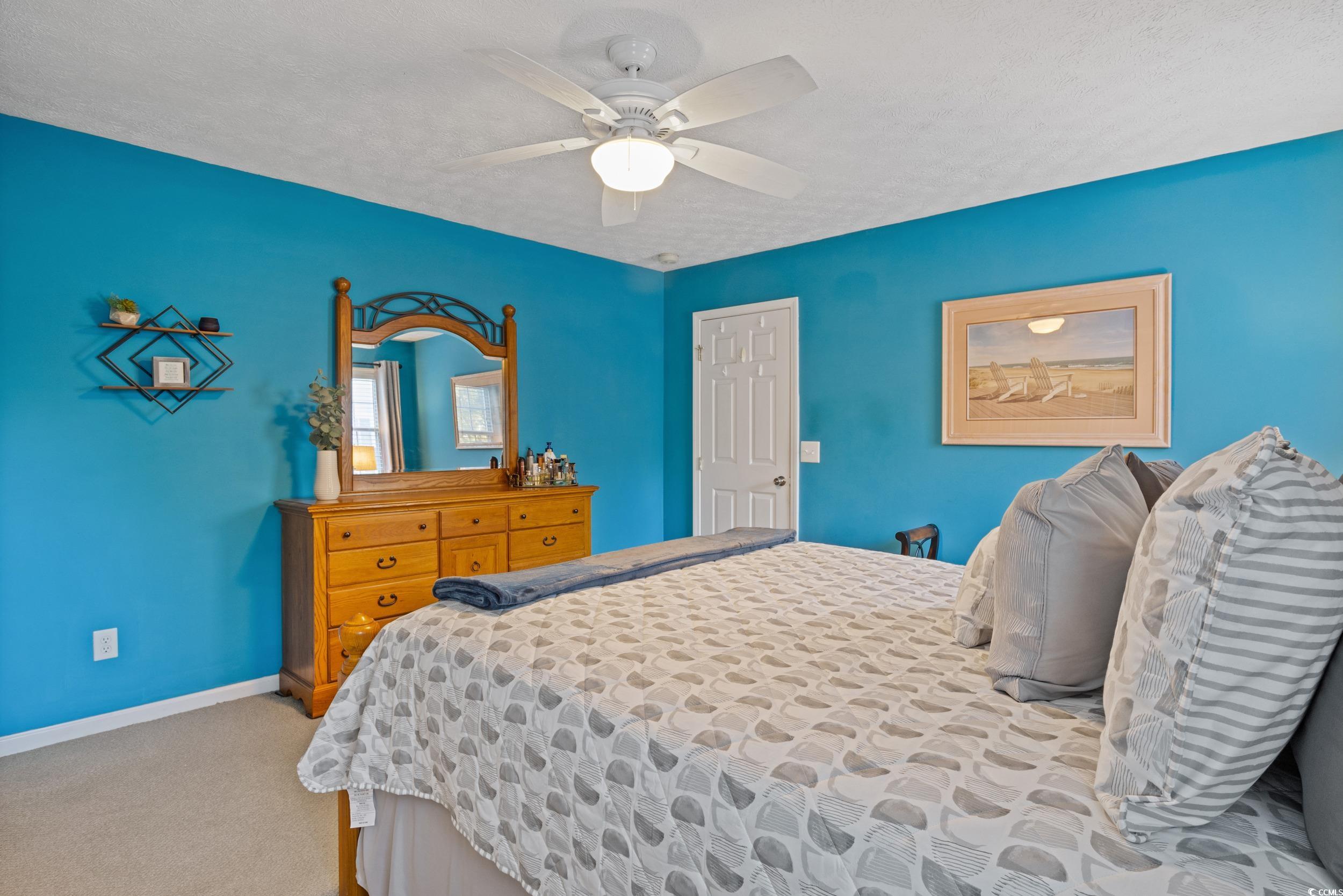 9605 Sullivan Drive Murrells Inlet, SC 29576 - Photo 27 of 40 Bedroom with ceiling fan, light colored carpet, an