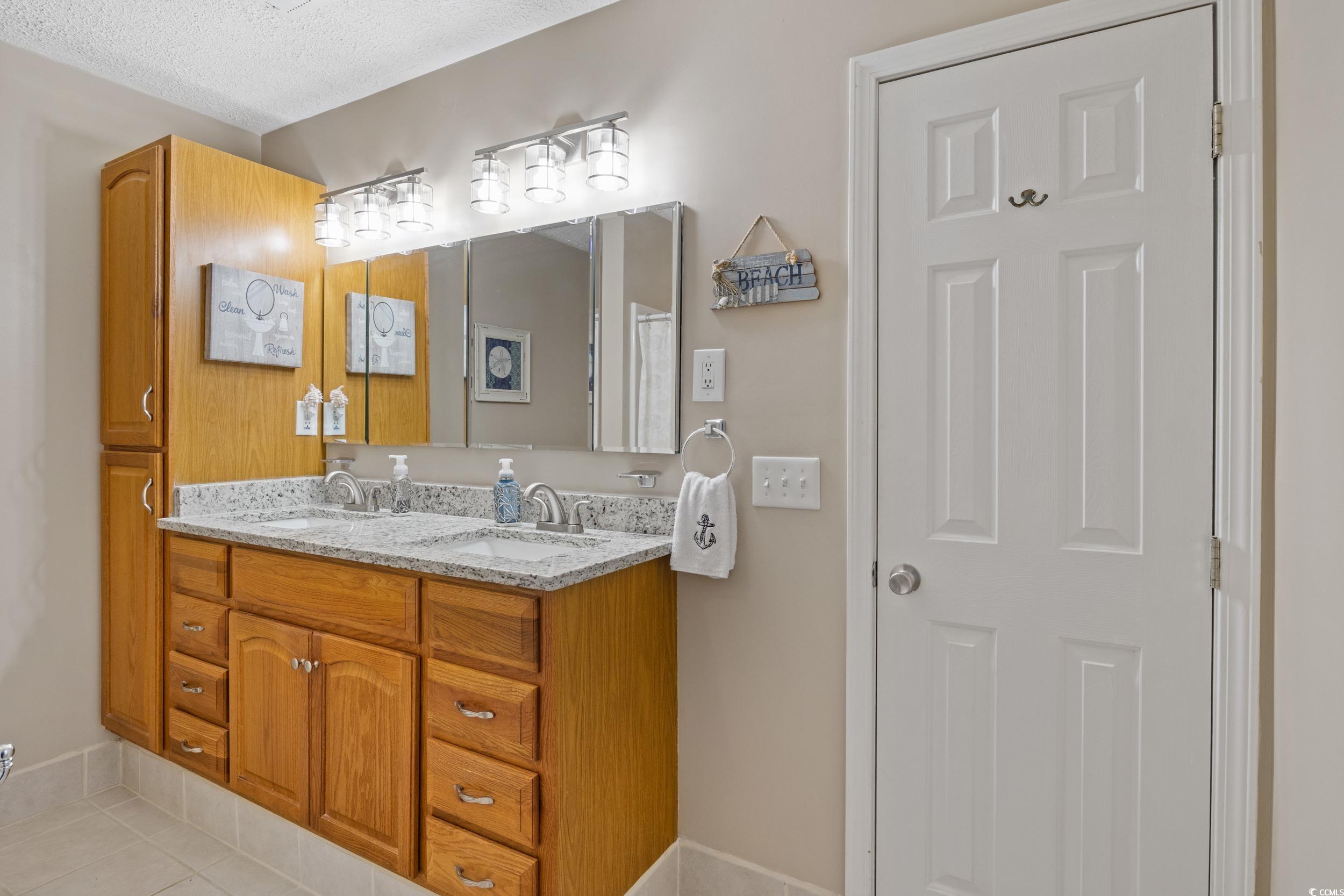 9605 Sullivan Drive Murrells Inlet, SC 29576 - Photo 28 of 40 Bathroom with tile patterned flooring, vanity, and