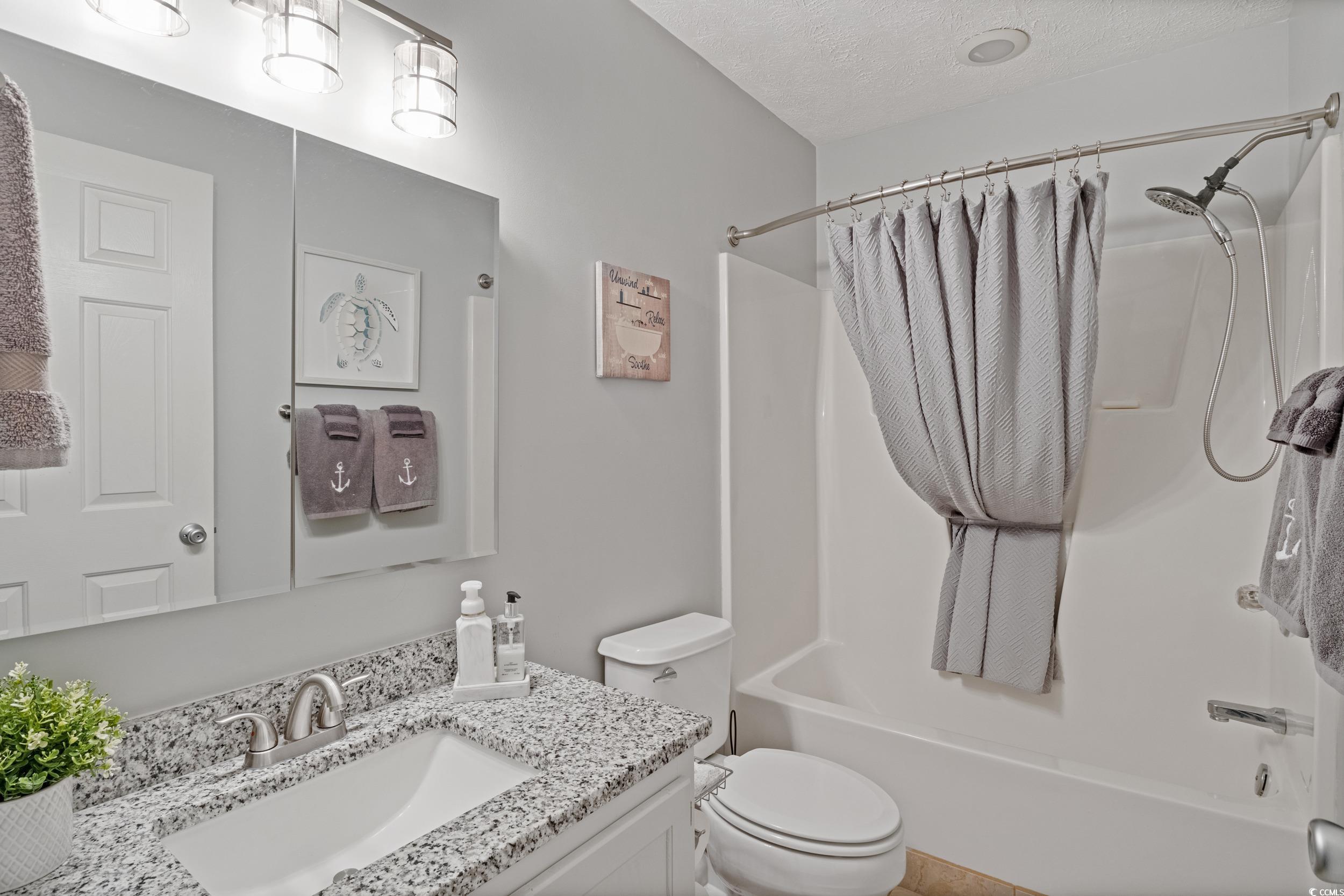 9605 Sullivan Drive Murrells Inlet, SC 29576 - Photo 32 of 40 Full bathroom featuring vanity, toilet, a textured