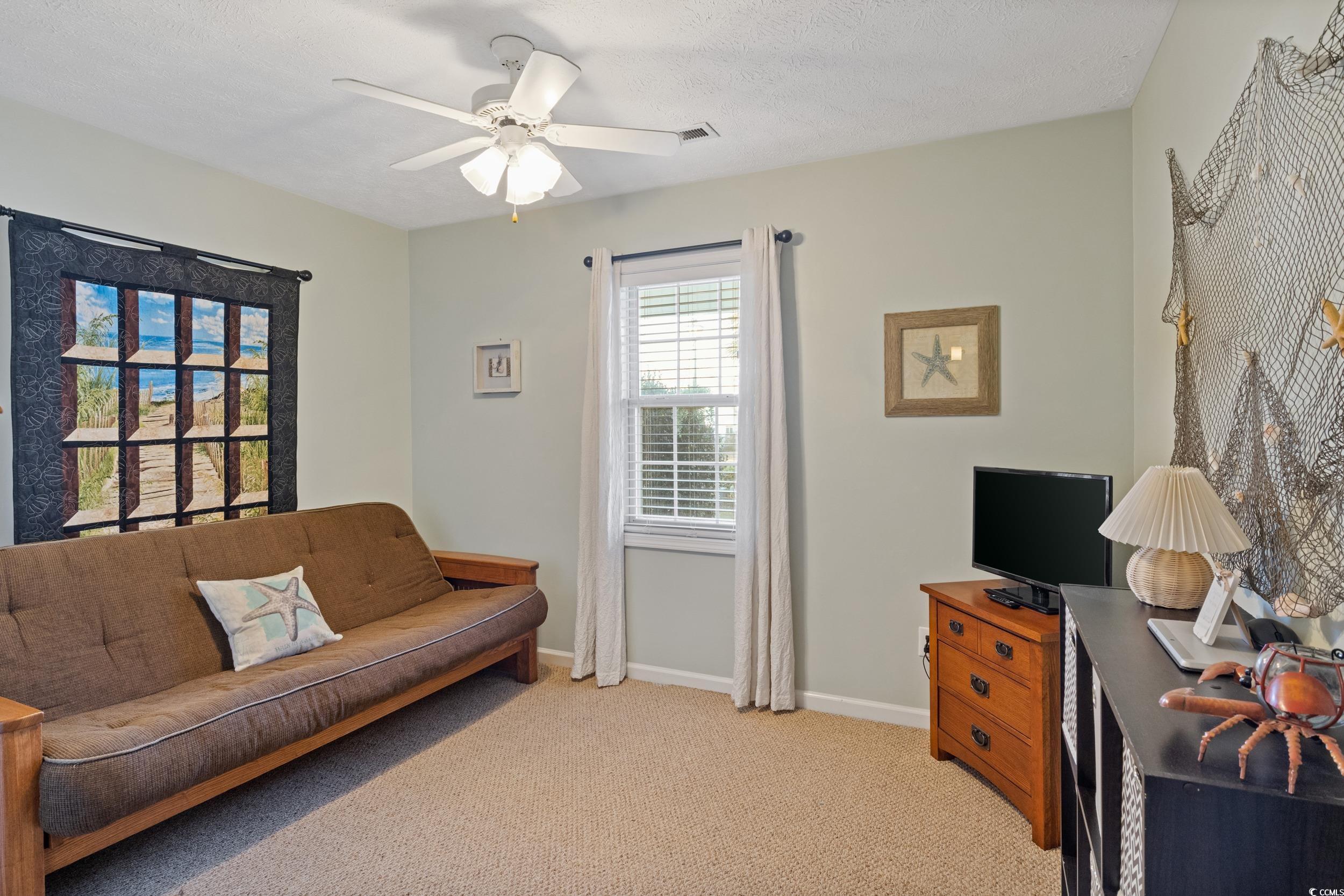 9605 Sullivan Drive Murrells Inlet, SC 29576 - Photo 33 of 40 Carpeted living room featuring ceiling fan and a t
