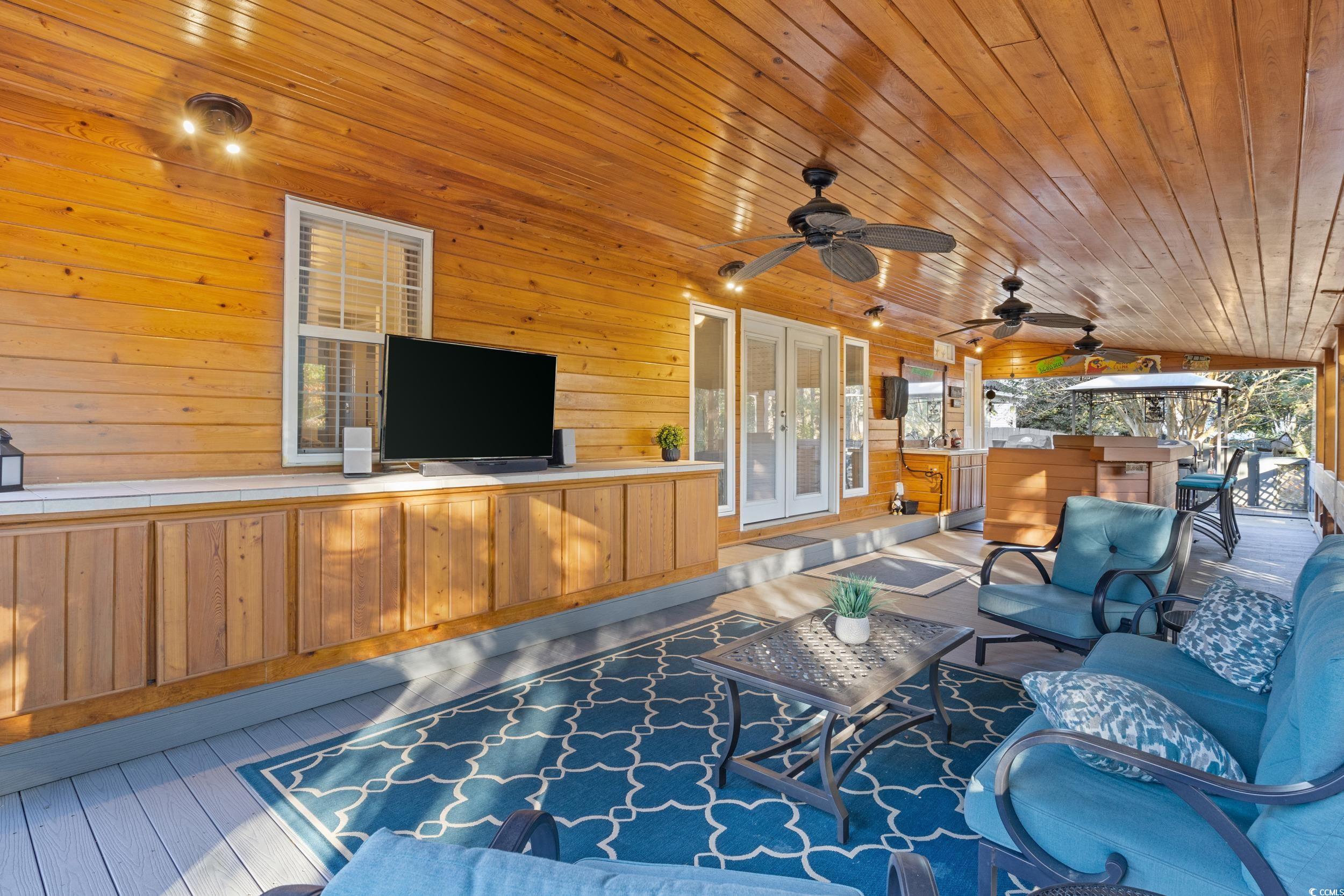 9605 Sullivan Drive Murrells Inlet, SC 29576 - Photo 38 of 40 Wooden deck with ceiling fan, french doors, and an