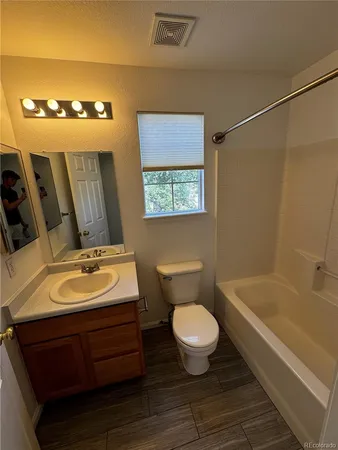 a view of a livingroom with a ceiling fan and window