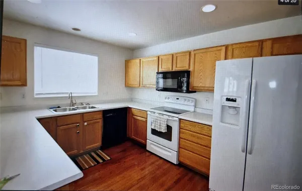 a kitchen with stainless steel appliances a stove a sink and a refrigerator