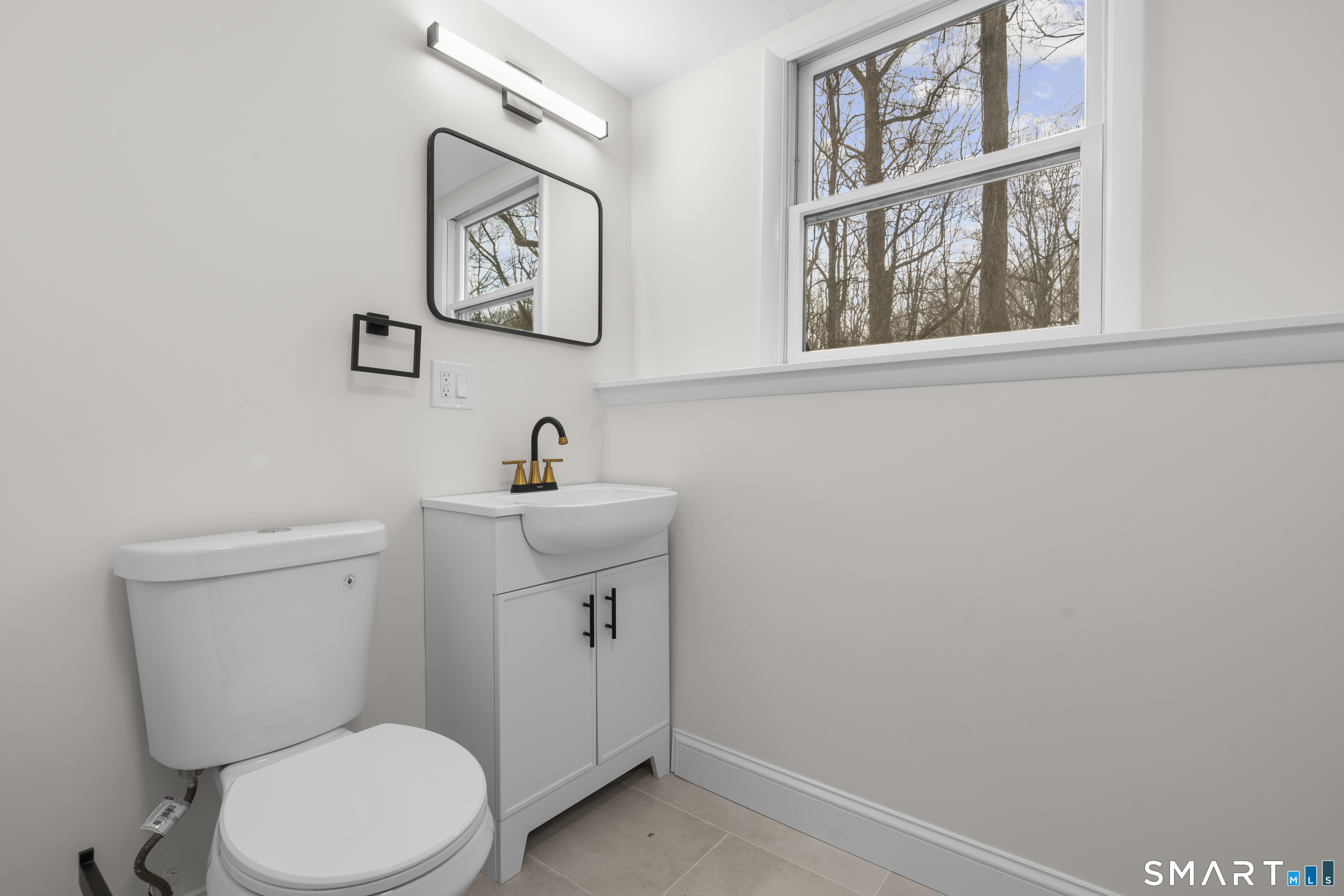 70 Dayton Road Redding, CT 06896 - Photo 26 of 38 a white toilet sitting next to a bathroom sink