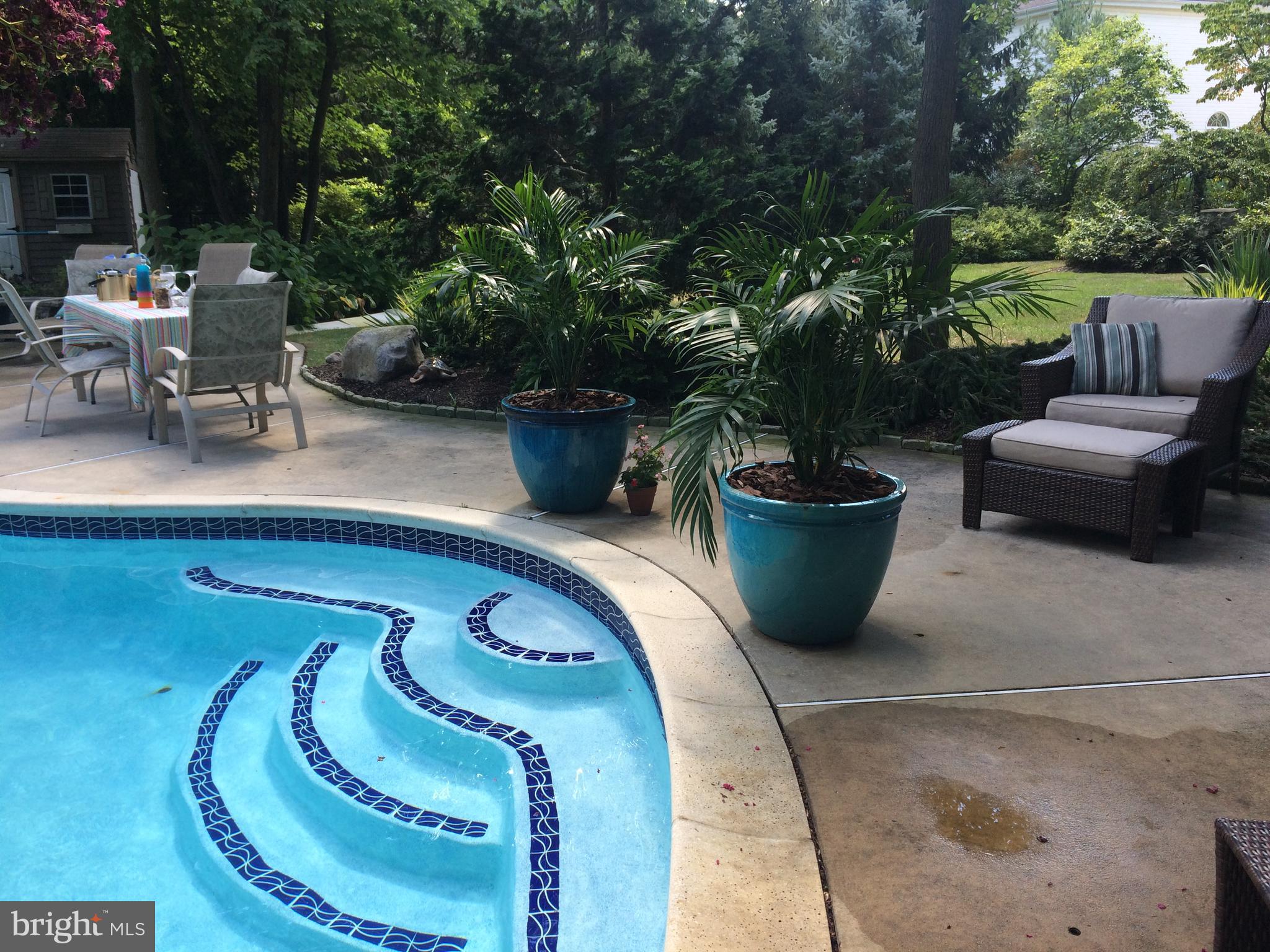 35 Stanwyck Road Mount Laurel, NJ 08054 - Photo 71 of 89 a view of a patio with table and chairs potted plants with large tree