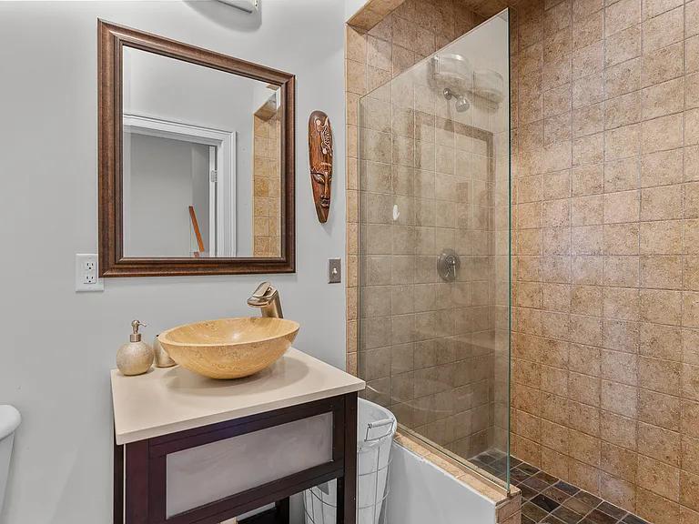 15 Riverview Avenue, Unit D Mashpee, MA 02649 - Photo 19 of 33 a bathroom with a sink vanity and a mirror