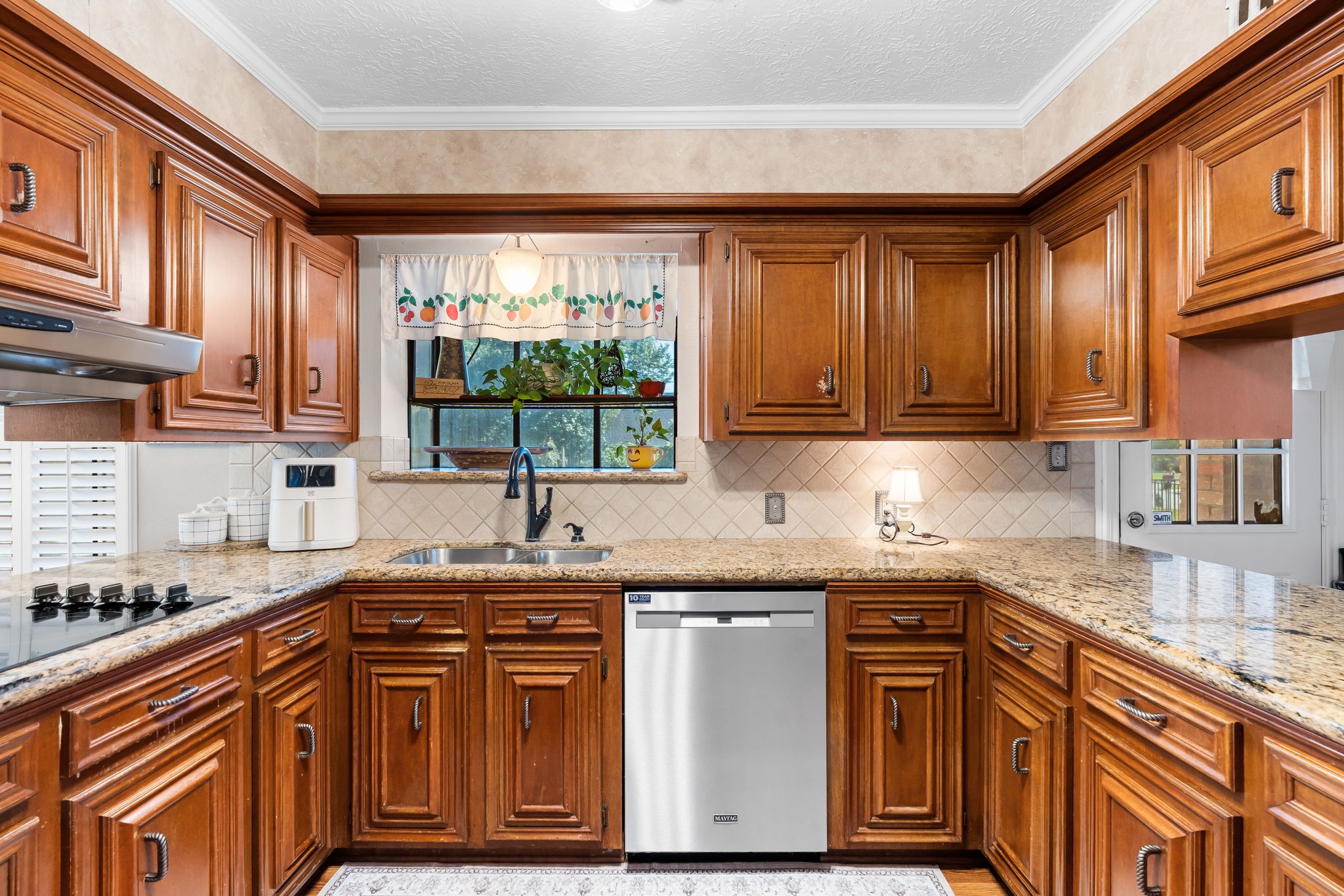 6971 Breezy Point Willis, TX 77318 - Photo 7 of 49 Lots of storage in upper and lower custom cabinets.