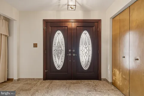 a hallway view with wooden floor and windows