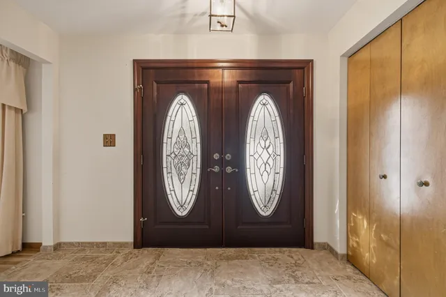 a hallway view with wooden floor and windows